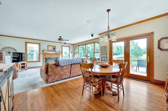 dining room featuring a healthy amount of sunlight, light hardwood / wood-style floors, and ornamental molding