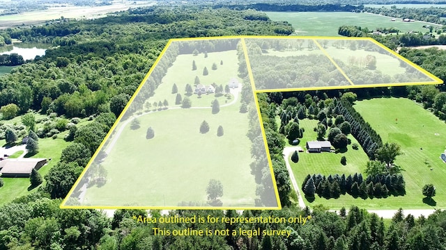 birds eye view of property featuring a water view and a rural view