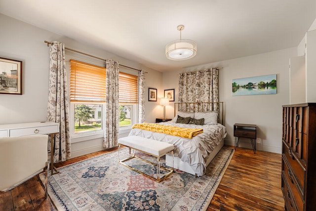 bedroom with dark hardwood / wood-style floors