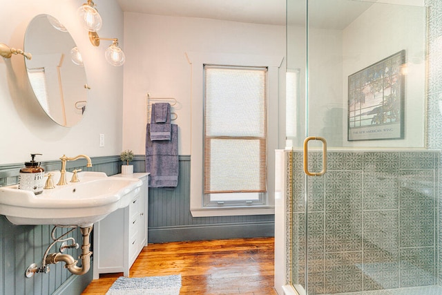 bathroom with tile walls, hardwood / wood-style floors, and an enclosed shower