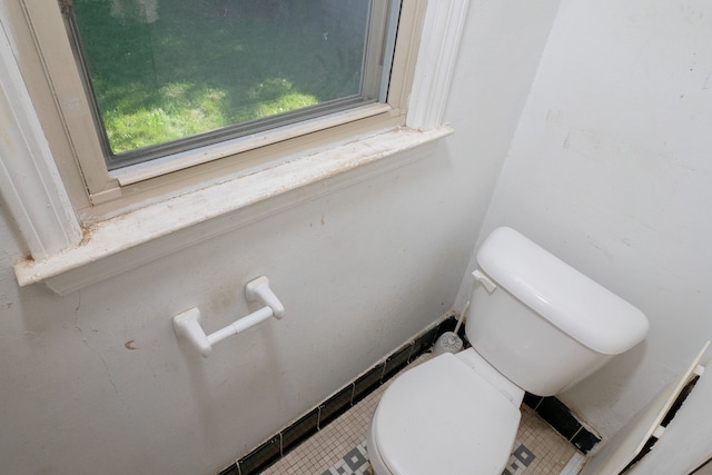 bathroom with tile patterned flooring and toilet