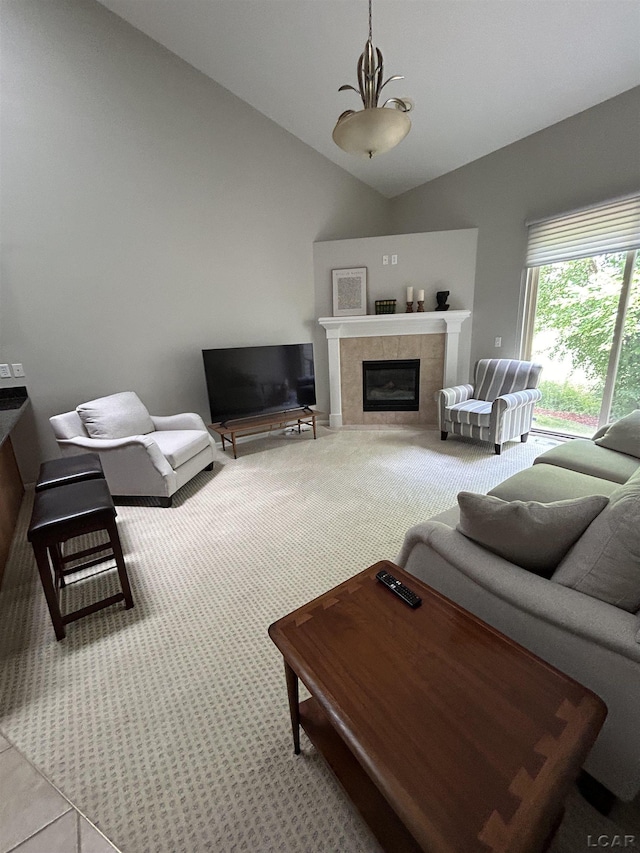 living room featuring lofted ceiling and a fireplace