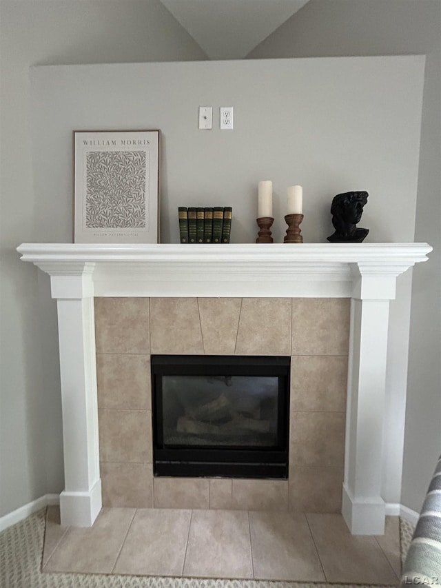 interior details featuring a tiled fireplace