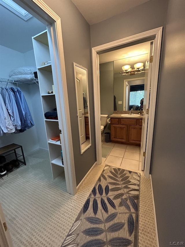 bathroom featuring toilet, tile patterned flooring, and vanity