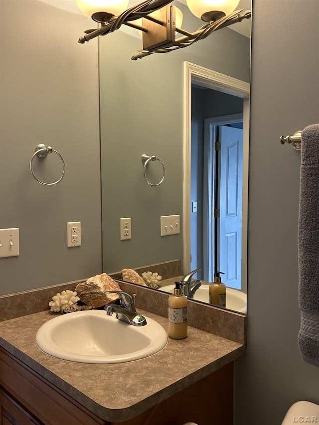 bathroom with a chandelier and vanity