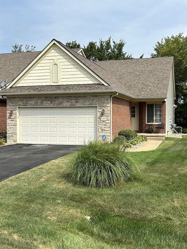 ranch-style home with a garage and a front lawn