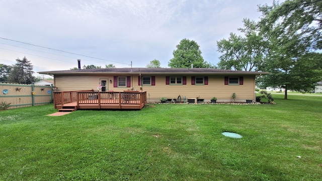 back of property featuring a lawn and a deck