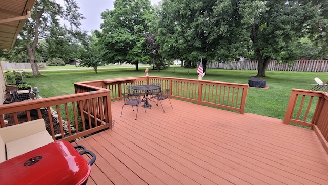 wooden terrace with a lawn