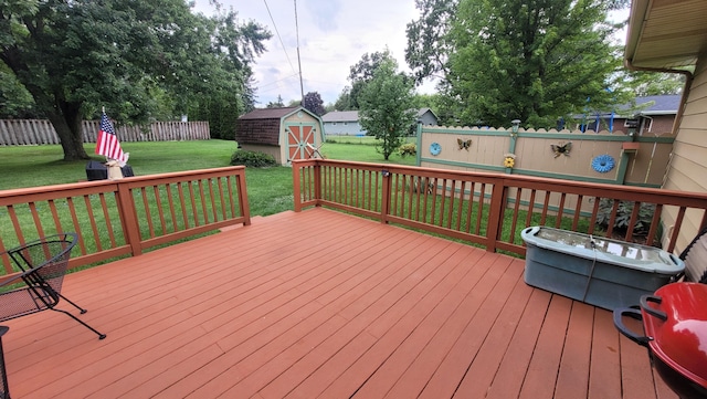 wooden deck with a yard and a storage shed