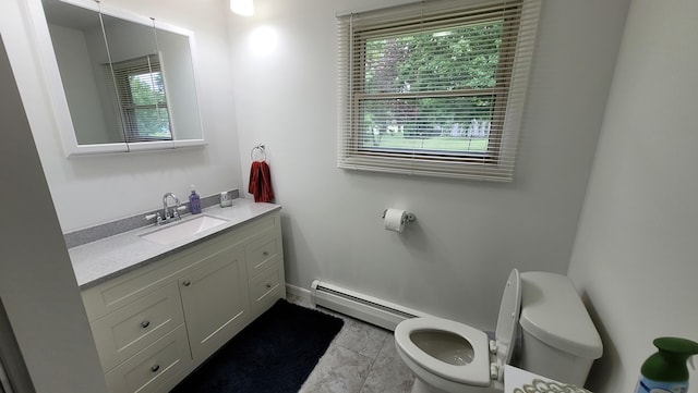 bathroom with tile patterned floors, vanity, a baseboard radiator, and toilet