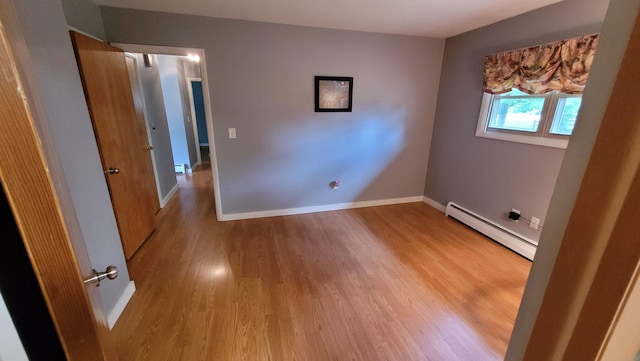 interior space featuring light wood-type flooring and a baseboard radiator