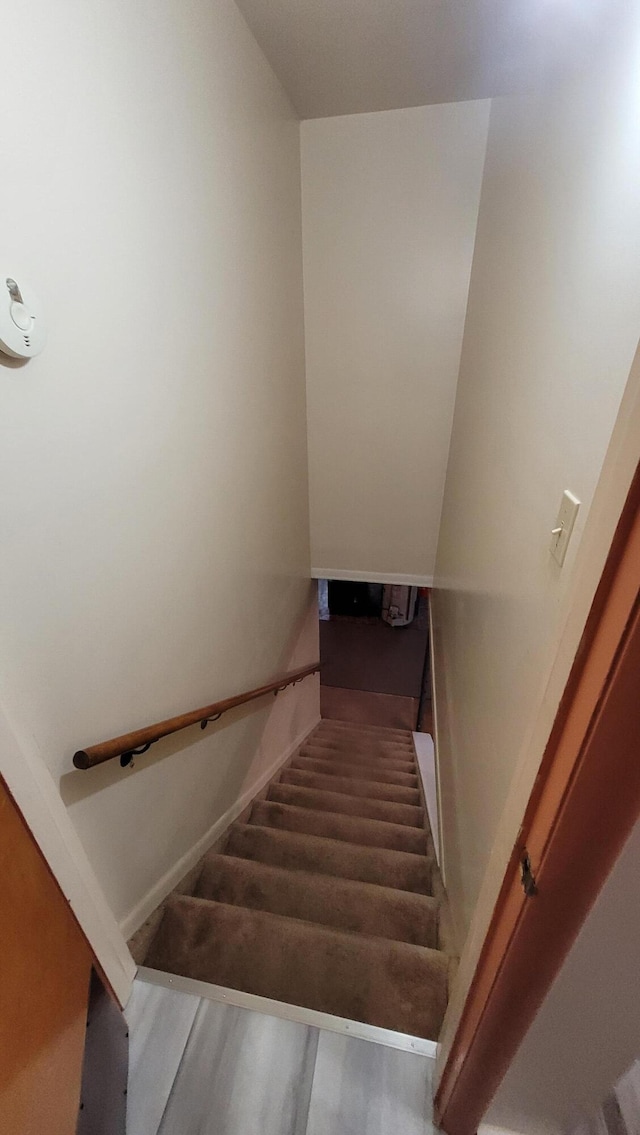 stairs featuring hardwood / wood-style floors