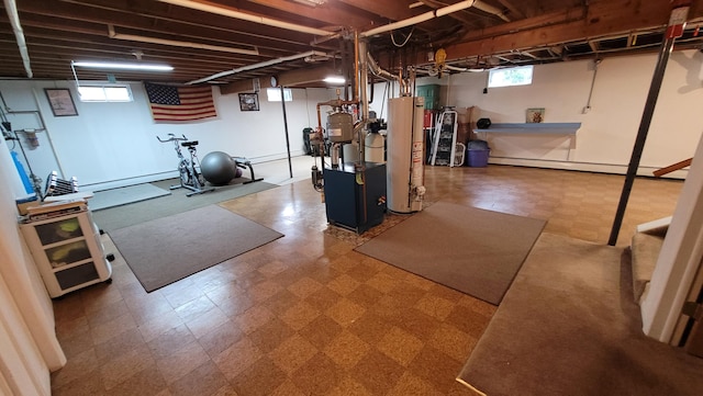 exercise room featuring gas water heater and a baseboard radiator