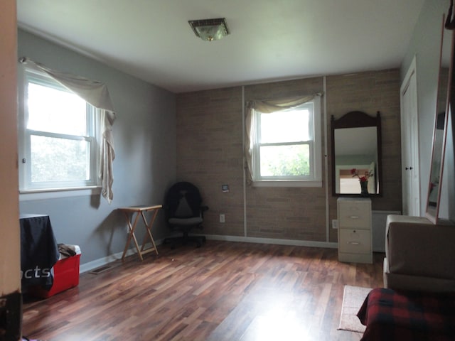 sitting room featuring plenty of natural light and dark hardwood / wood-style flooring