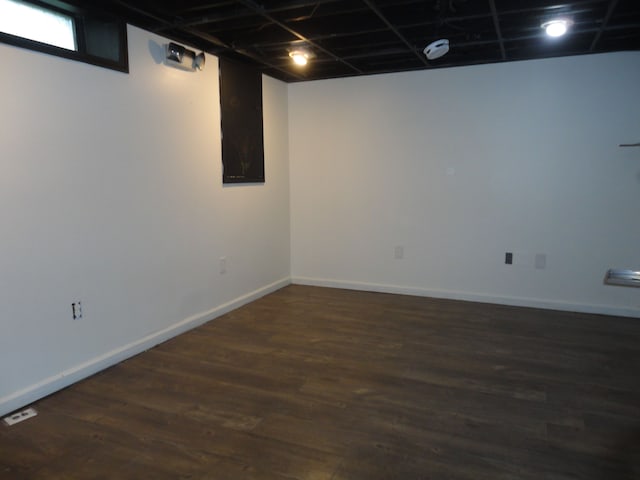 basement featuring dark hardwood / wood-style flooring