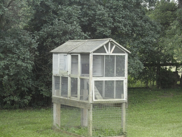 view of outbuilding with a lawn