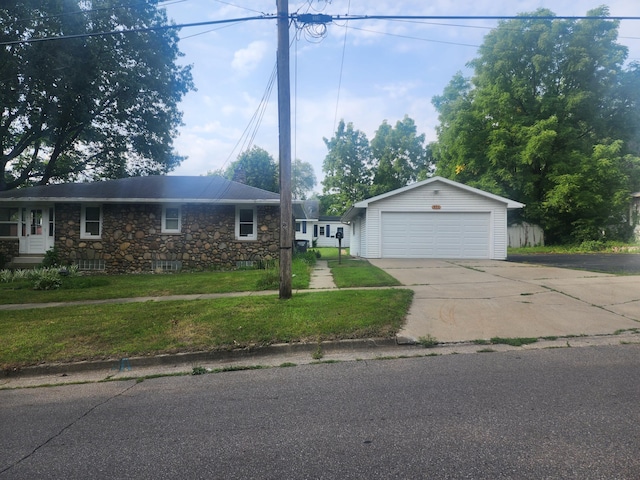 single story home with a front lawn, an outdoor structure, and a garage