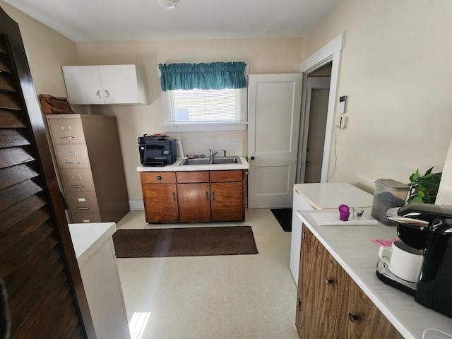 kitchen featuring white cabinets and sink