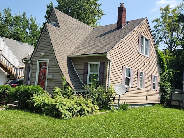 rear view of property with a lawn