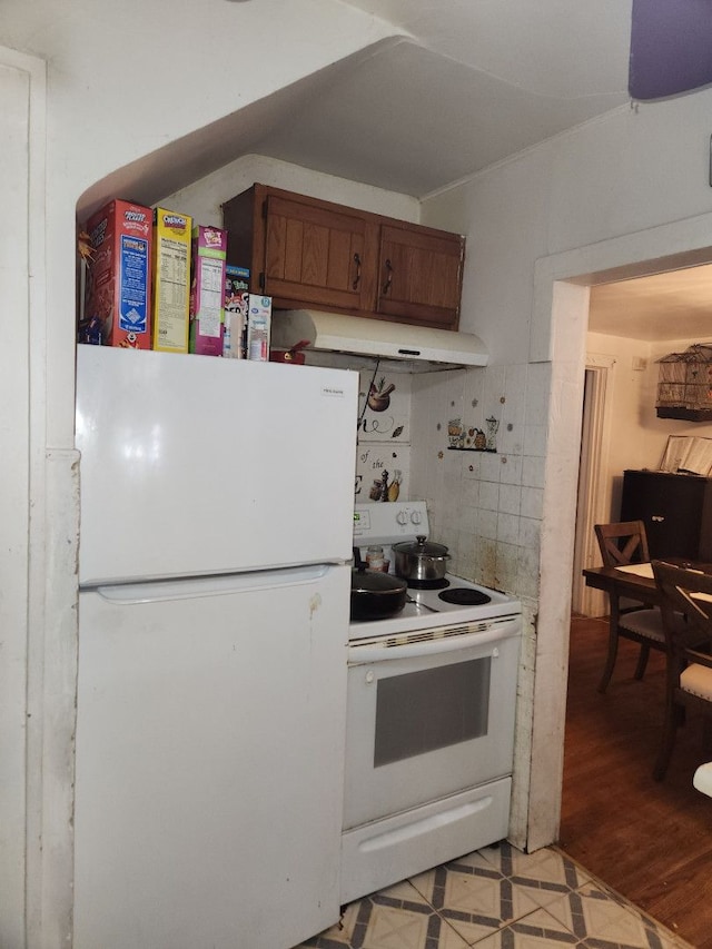 kitchen featuring light wood-type flooring and white appliances