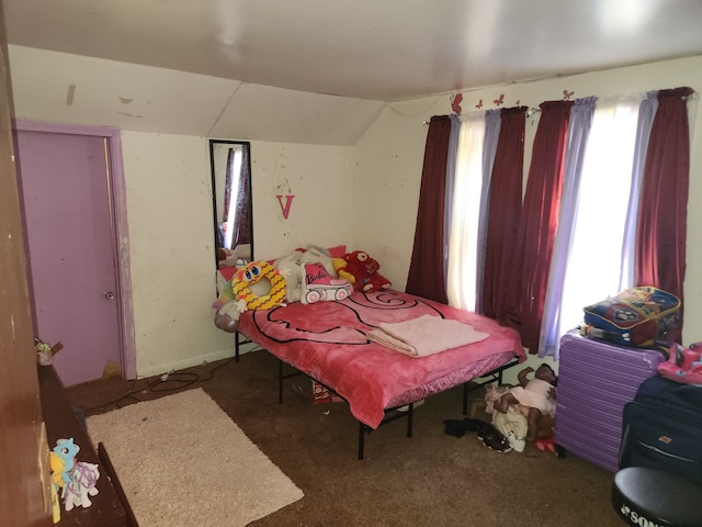 bedroom with carpet and lofted ceiling