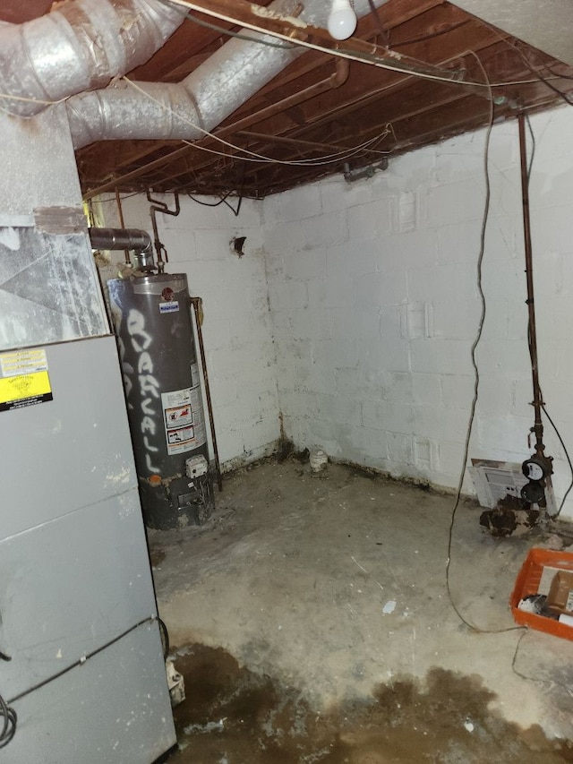 basement featuring heating unit and water heater