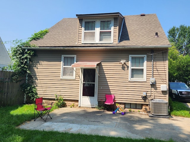 rear view of property with cooling unit and a patio area