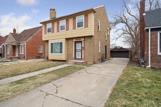 view of front of home with a front yard, an outdoor structure, and a garage