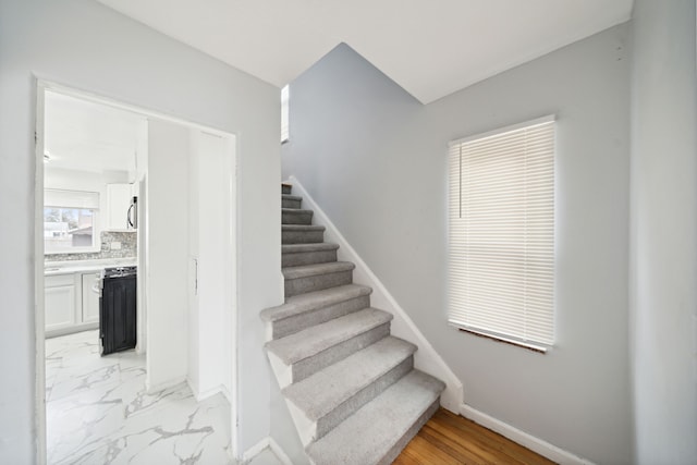 stairs featuring hardwood / wood-style floors