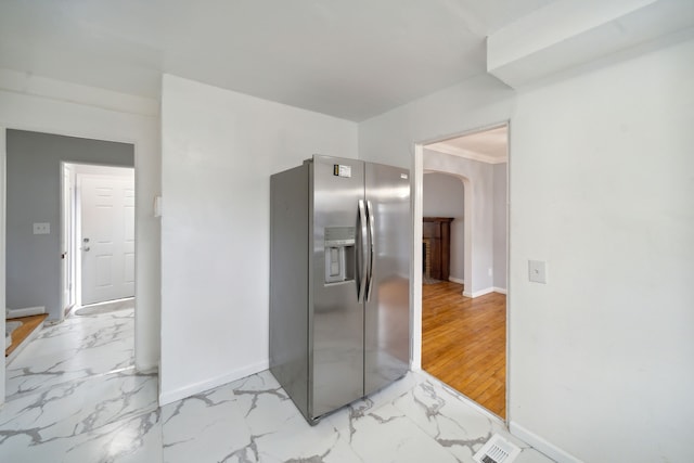 kitchen featuring stainless steel fridge with ice dispenser and light wood-type flooring