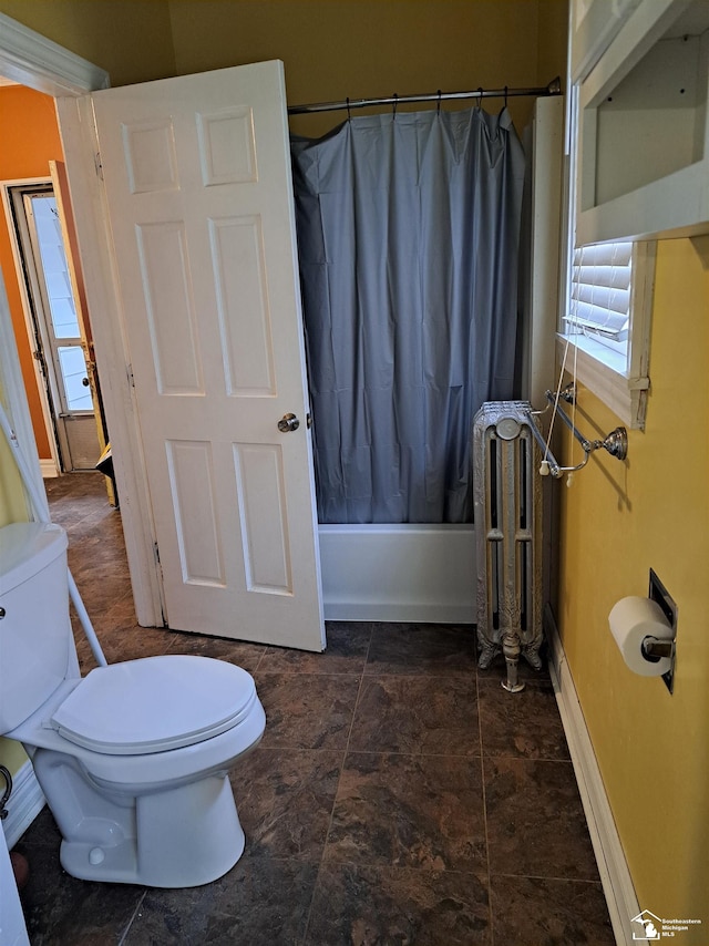 bathroom with radiator, a healthy amount of sunlight, shower / bath combo, and toilet