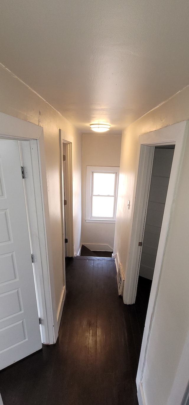 hall featuring a wall mounted air conditioner and dark hardwood / wood-style flooring