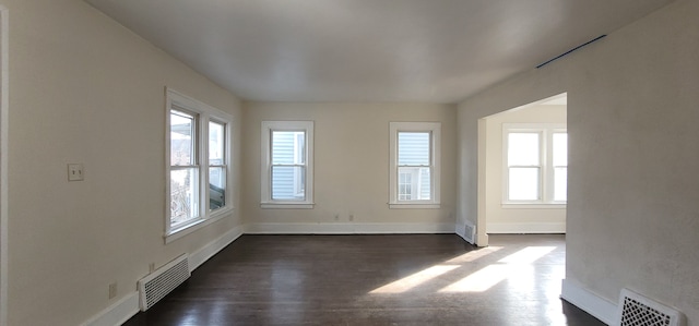 spare room with dark hardwood / wood-style flooring