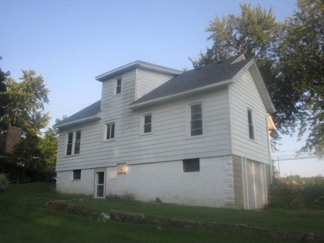 rear view of property featuring a yard