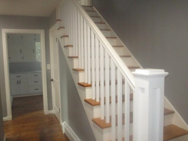 stairs featuring hardwood / wood-style floors