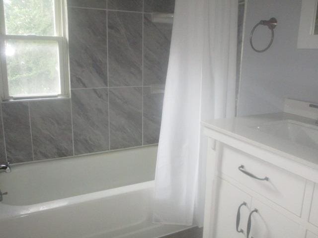 bathroom with vanity and shower / bath combo with shower curtain