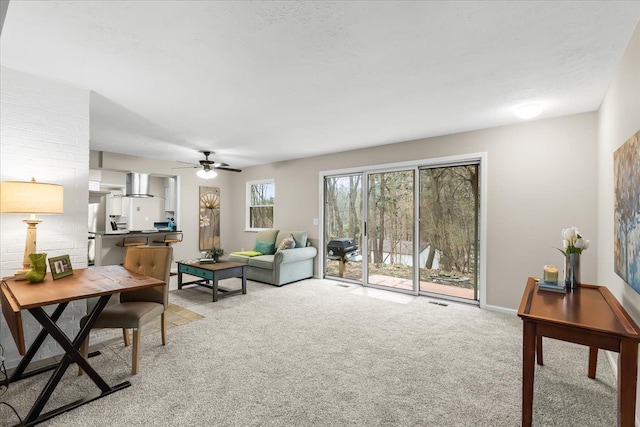 carpeted living room featuring ceiling fan