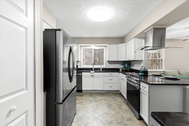 kitchen with extractor fan, a textured ceiling, decorative backsplash, white cabinets, and appliances with stainless steel finishes