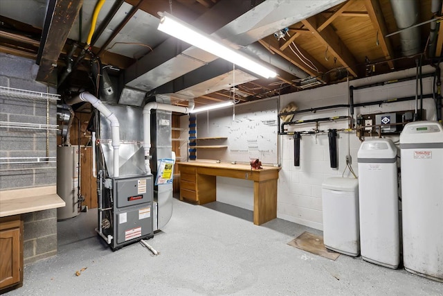 basement with a workshop area, water heater, and heating unit