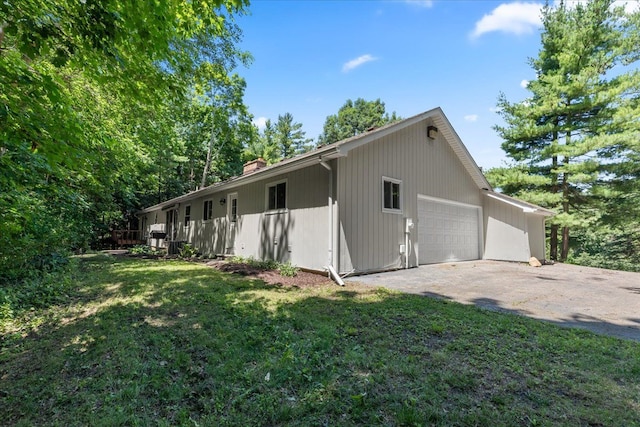 view of home's exterior featuring a garage and a lawn