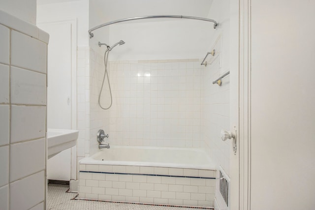 bathroom featuring tile patterned flooring and tiled shower / bath combo