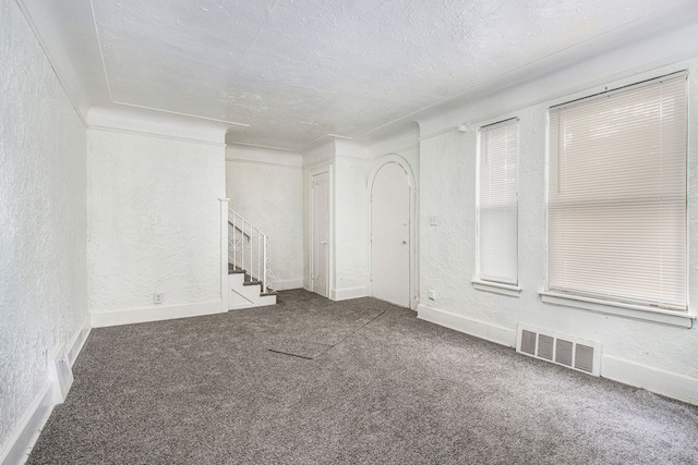 15766 Snowden St, Detroit, MI 48227 - spare room with a textured wall, stairs, carpet, a textured ceiling, and baseboards
