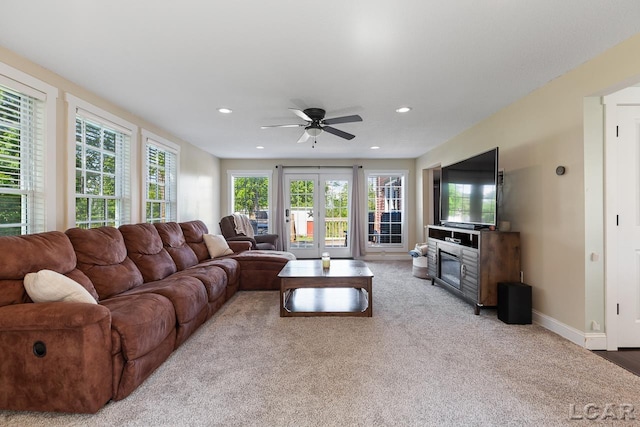 carpeted living room featuring ceiling fan