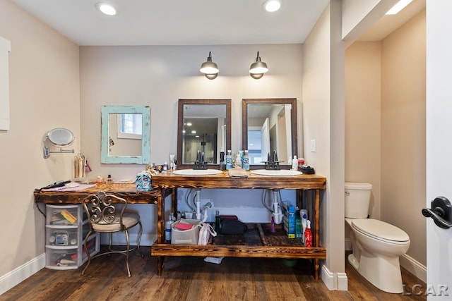 bathroom featuring hardwood / wood-style flooring, vanity, and toilet