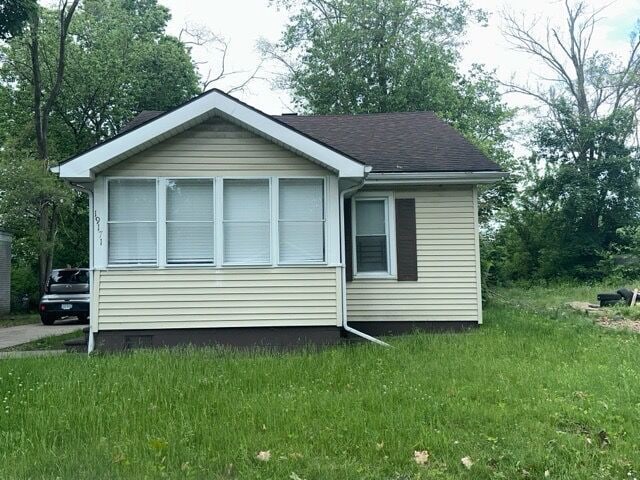 view of property exterior featuring a lawn