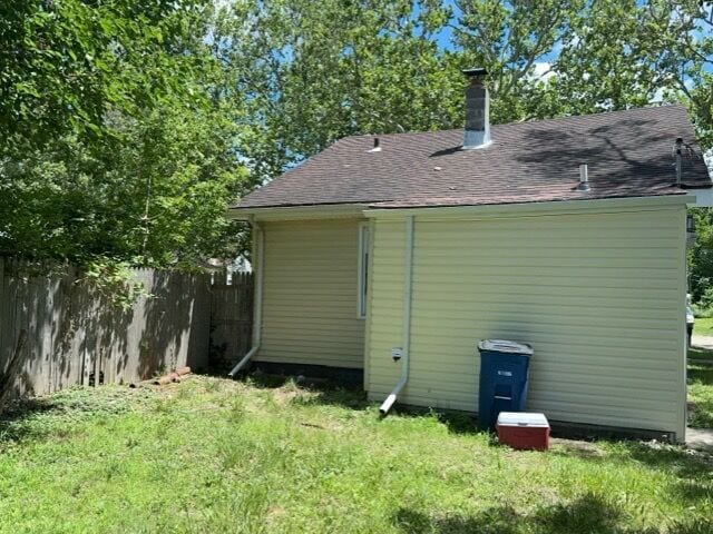 rear view of property with a lawn