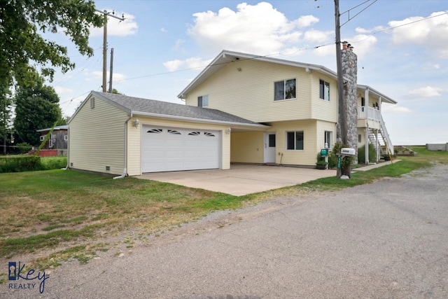 view of front of property featuring a garage and a front lawn