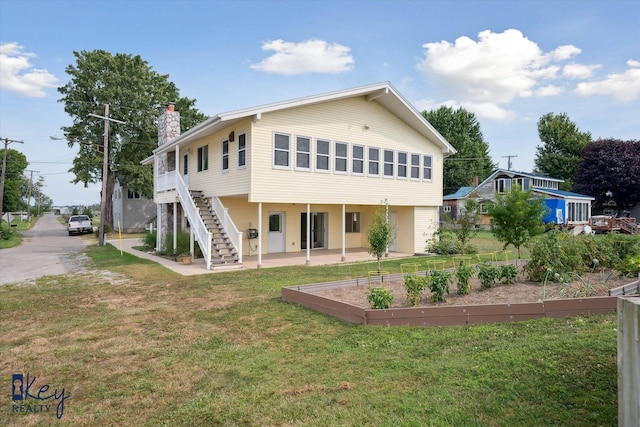 6800 Lakeshore Dr, Newport, MI 48166 - rear view of property with a vegetable garden, a chimney, a yard, a patio, and stairs