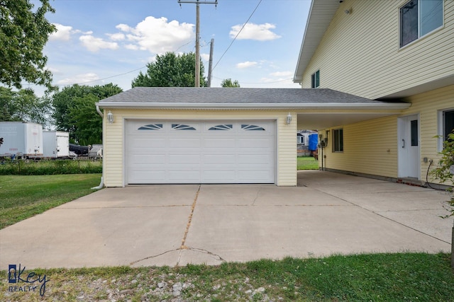 garage featuring a yard and a carport