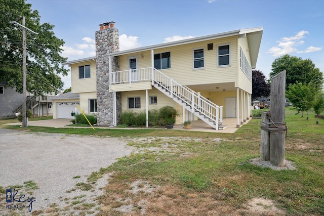 6800 Lakeshore Dr, Newport, MI 48166 - view of front facade with stairway, a chimney, driveway, and a garage